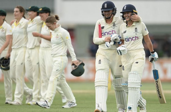 Kate Cross and Sophie Ecclestone walks back after helping England draw the Ashes Test. PC: Getty Images
