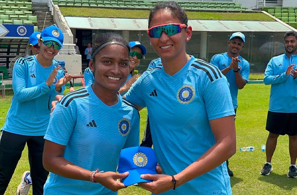 Harmanpreet Kaur hands over the debut India cap to Anusha Bareddy. PC: BCCI